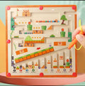 Children's toy with a maze and colorful blocks on a pink surface