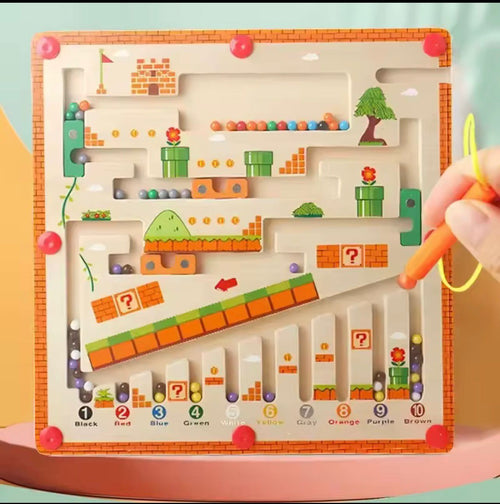 Children's toy with a maze and colorful blocks on a pink surface