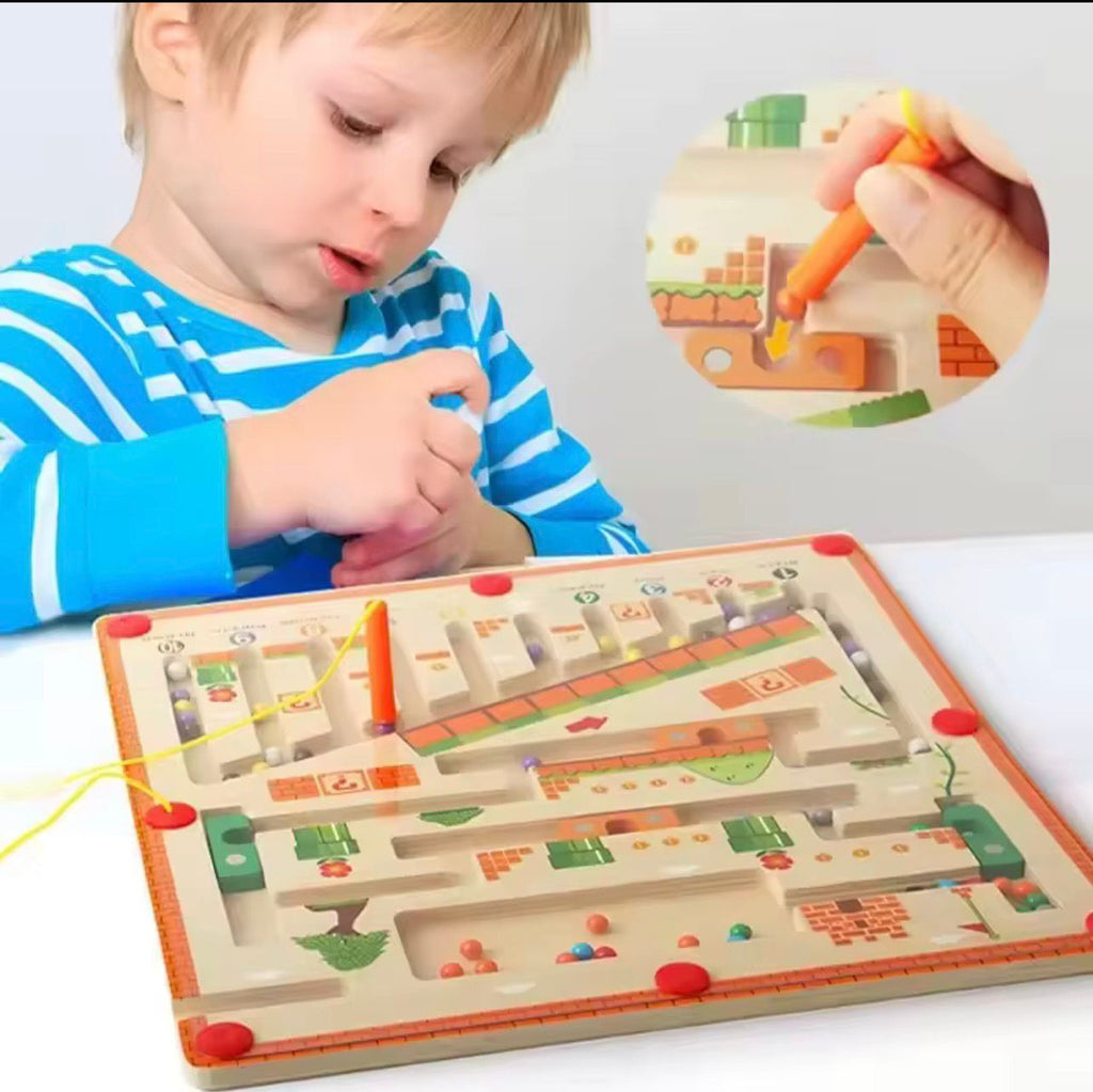 Child playing with a wooden maze toy on a white surface