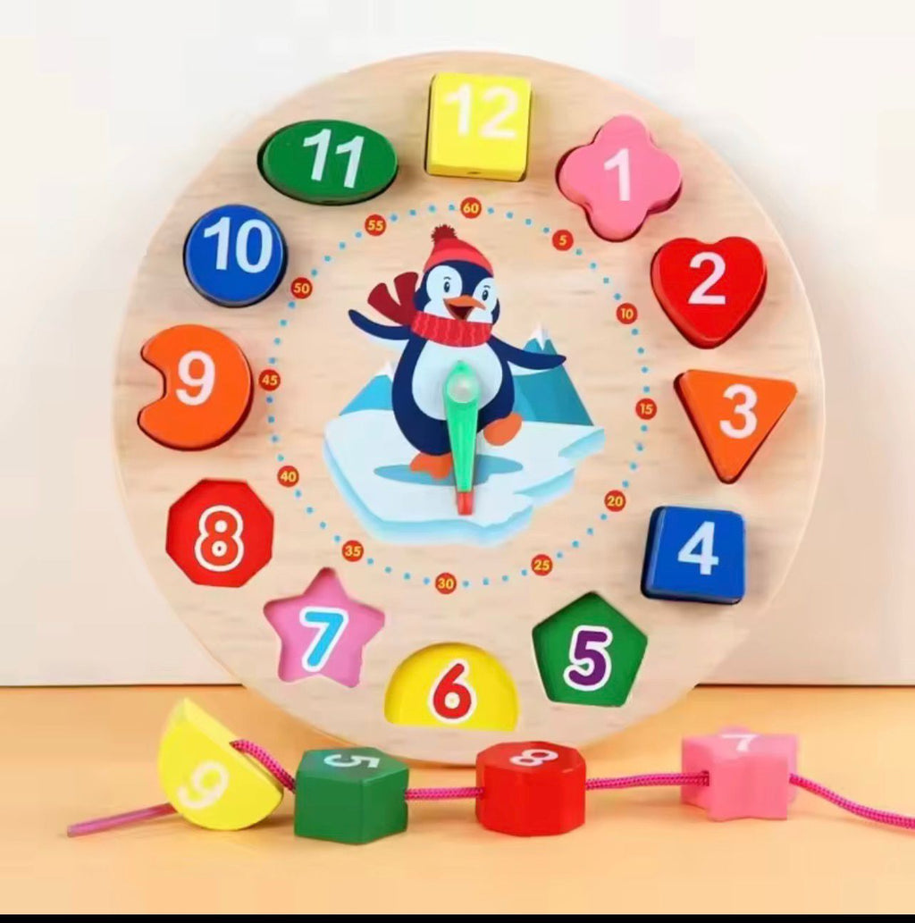 Wooden educational toy clock with colorful numbers and shapes on a light background