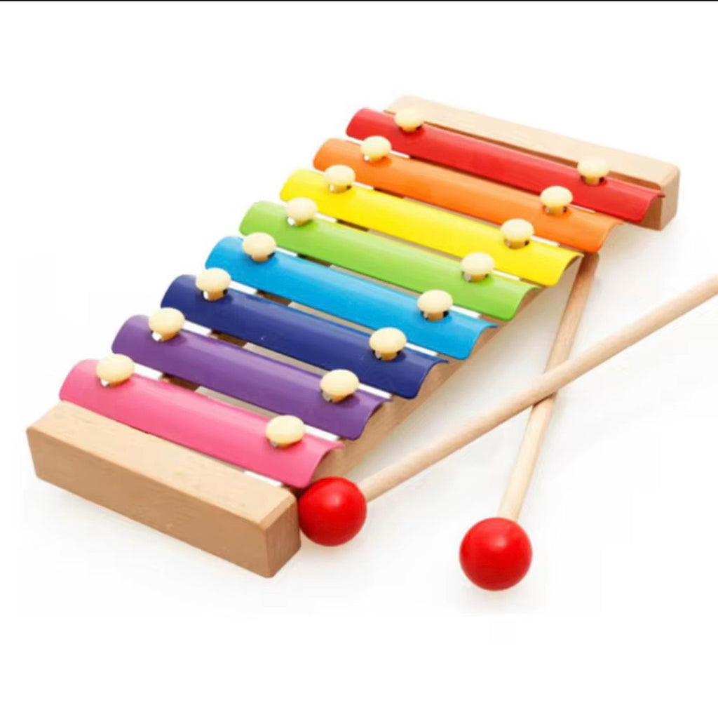 Colorful wooden xylophone with two mallets on a white background